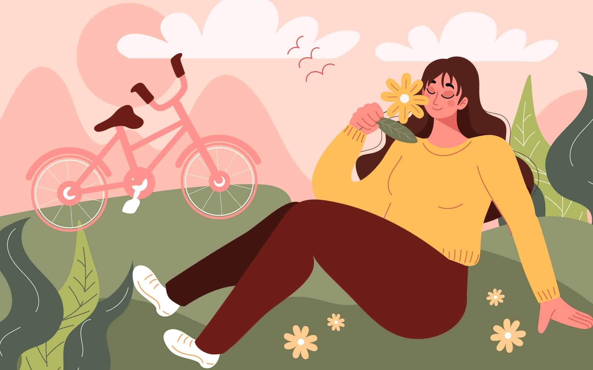 A woman sitting in the park smelling a flower; mental health and resilience